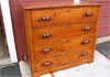 Pine chest of drawers with walnut pulls with natural finish.