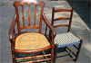 Cane armchair and antique ladder back chair with shaker tape seat.